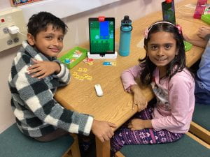 Two engaged Cactus Ranch Elementary students participating in an Ozmo coding digital citizenship maker space lesson led by Mrs. Weathers in the school library. The students collaborate on Ozmo coding projects, combining technology, creativity, and digital citizenship concepts.